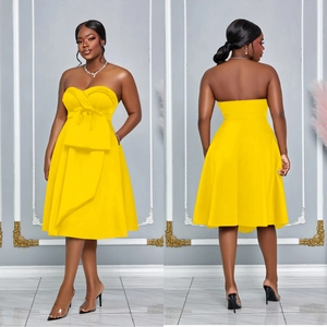 Front and back detail of a vibrant yellow strapless A-line dress with a large bow detail
