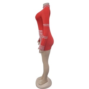 Detail of red rhinestone jumpsuit showing side view with silver studs on sleeve and hem