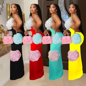 Detail of elegant halter neck maxi dresses with large decorative 3D floral chest motifs