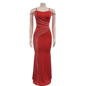 Detailed view of red fishtail evening dress with silver rhinestone accents and mesh panels