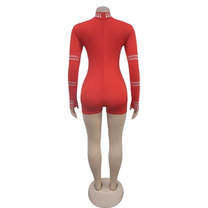 Detail of red slim fit romper featuring rhinestones and a back zipper closure