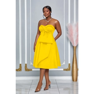 Detail of a bright yellow strapless A-line dress featuring a large waist bow decoration