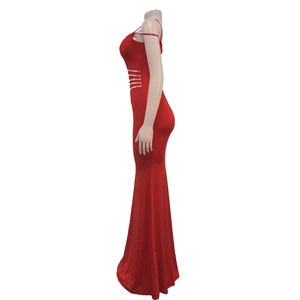 Detail of red fishtail evening dress with rhinestone straps and sequined waistline