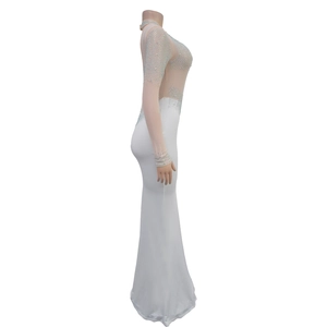 Close-up of white slim fit gown featuring sheer mesh and sparkling silver rhinestones