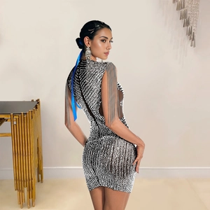 Detail of silver fringe shoulder tassels on a backless polka dot bodycon dress