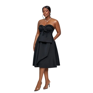 Detail of elegant black strapless midi dress featuring a large waist bow and sleek silhouette