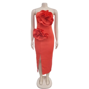 Detailed view of the 3D floral decoration on a red strapless dress with thigh-high slit