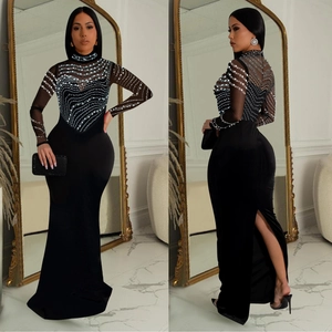 Elegant black long sleeve evening dress with sheer mesh top and white beaded wave patterns