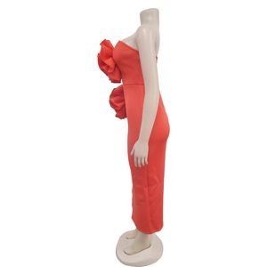 Close-up of red bodycon dress featuring 3D floral accents and high side slit detail