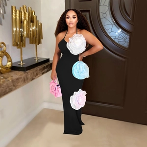 Close-up of black halter dress featuring three large 3D floral accents in pastel colors