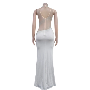 Detail of white evening gown with sheer mesh back and silver rhinestone swirling patterns