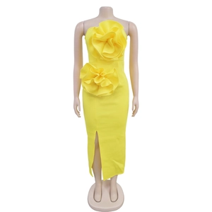 Detail of a yellow strapless dress featuring 3D floral accents and a stylish side slit