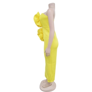 Detail of yellow strapless jumpsuit featuring dramatic double-layered side ruffles