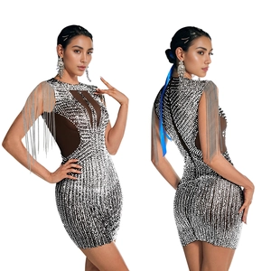 Detail of a sparkling sequin mini dress with silver fringe shoulder tassels and mesh panel