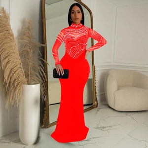 Detail of red floor-length evening dress with rhinestones and sheer mesh sleeves