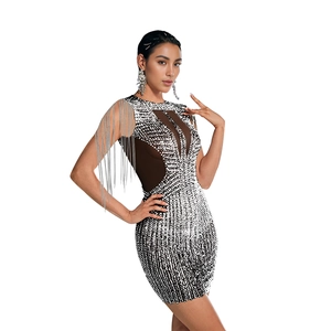 Detailed view of rhinestone mini dress featuring metallic fringe shoulder and mesh neckline