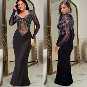 Elegant black long sleeve evening dress with sparkling rhinestones and sheer mesh details