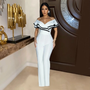 Detail of off-shoulder neckline with ruffle trim and black contrast piping on white jumpsuit