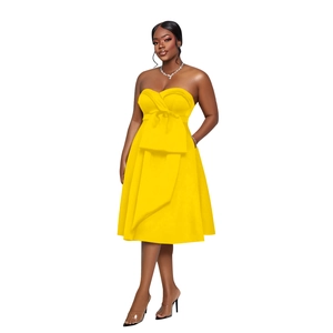 Detail of a bright yellow strapless midi dress featuring a large decorative waist bow