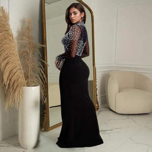 Detailed view of elegant evening dress with shimmering rhinestones and a thigh-high slit