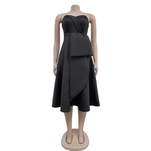 Detail of elegant black strapless midi dress featuring a large asymmetrical waist bow accent