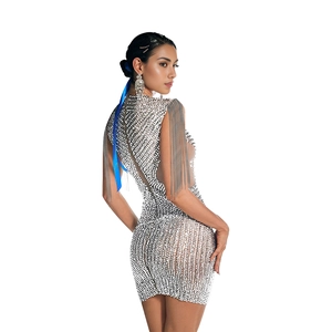 Detailed view of silver sequin tassels and rhinestone embellishments on a mini dress
