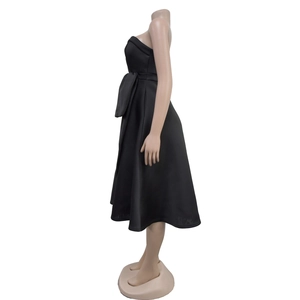 Detail of a black strapless midi dress featuring a large waist bow and A-line silhouette