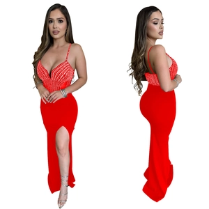 Detail view showing red V-neck dress with sparkling rhinestones and high slit side profile