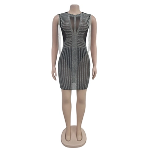Close-up of black fringe shoulder detail and silver rhinestones on a mesh party dress