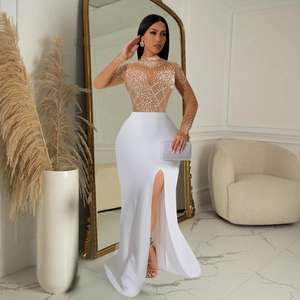 Detail of high-slit long dress featuring sheer rhinestone bodice and elegant white skirt