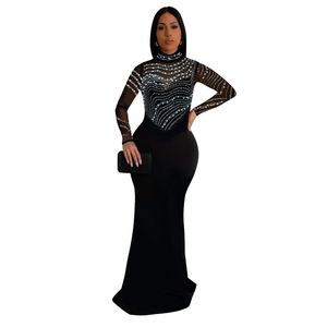Detail of sheer mesh neckline and shimmering rhinestone patterns on black evening gown