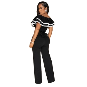 Detail of the ruffle neckline with white contrast trim on a black sleeveless jumpsuit