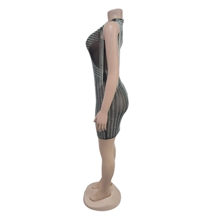 Detail of black sheer mesh dress with vertical rhinestones and long tassel chains