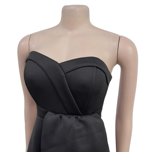 Detail of sweetheart neckline and criss-cross pleated bodice on a black sleeveless dress