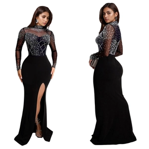 Detail of black rhinestone evening dress with sheer mesh sleeves and side high slit