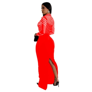 Detail of red evening dress featuring sheer mesh with rhinestones and a side slit design