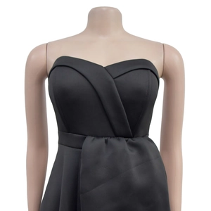 Detail of elegant black strapless midi dress featuring unique crisscross halter neckline