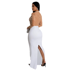 Detail of white slim fit maxi dress featuring a high waist and elegant back slit design