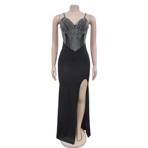 Detailed close-up of a black evening gown featuring silver rhinestones and a high leg slit