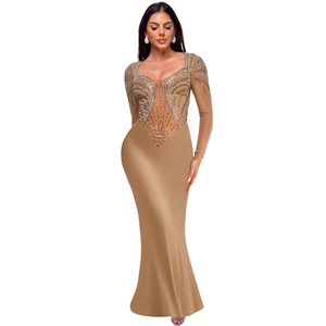 Detailed view of rhinestones and mesh patchwork on long sleeve evening mermaid gown