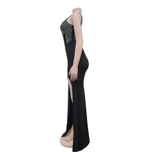Detail view of the side high slit and silver rhinestone embellishment on the black gown