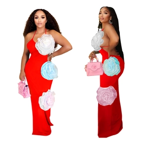 Detail view of red halter maxi dress featuring 3D floral accents on side seam