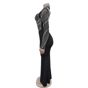 Close-up of black mesh sleeves with intricate white sequins and elegant geometric patterns