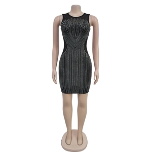 Detail of black bodycon dress featuring geometric silver rhinestone patterns