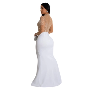 Detail of white evening dress featuring sheer mesh with sequins and fishtail skirt design