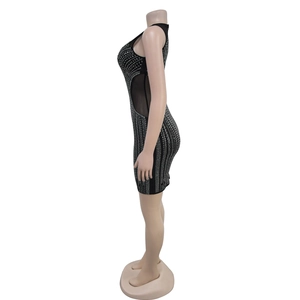 Detail of black sleeveless rhinestone mini dress featuring mesh side panels on mannequin