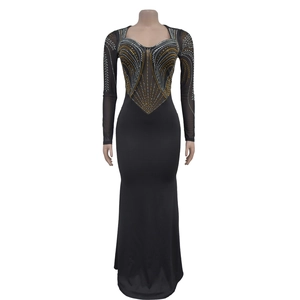 Close-up of sparkling rhinestones and mesh patchwork on a black long sleeve evening gown