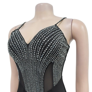 Close-up of black V-neck bodysuit with sparkling silver rhinestones and mesh panels