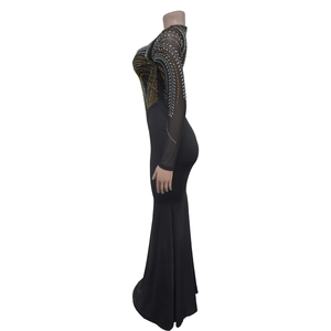 Detail of rhinestone patterns and sheer mesh long sleeves on this black formal dress
