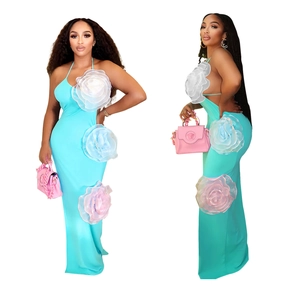 Detail of blue halter dress featuring 3D floral accents and elegant backless design